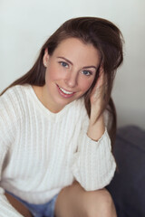 Fototapeta premium Effortlessly Beautiful: Lovely Girl Strikes a Pose on a Grey Background, Exuding Confidence and Radiance