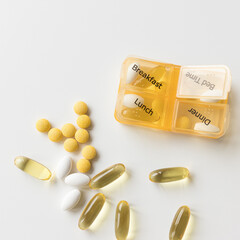 Daily medicine dispenser. Four times day weekly container and pills