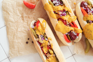 Unleash Your Hunger: Mouthwatering Hot Dog on the Table, the Perfect Treat for Any Time of Day