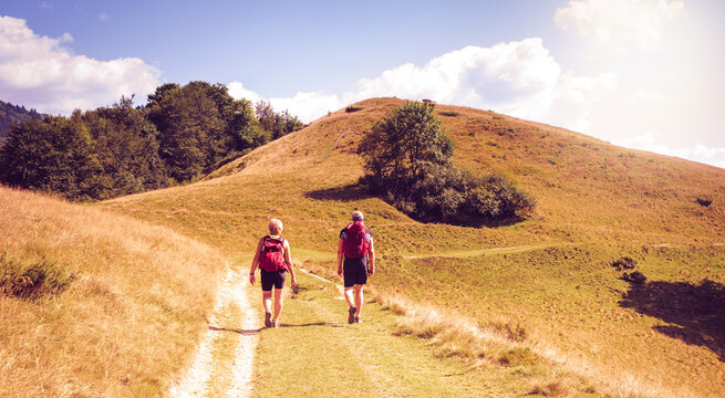 Couple of men and women hiking in the mountains of the Carpathians in Ukraine