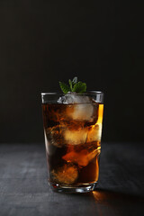 Fototapeta na wymiar Stay Refreshed: Iced Tea with mint on a Dark Background, the Perfect Beverage to Quench Your Thirst and Cool You Down