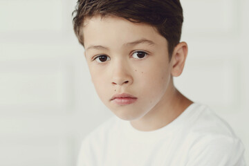 Childhood. Boy in white shirt posing portrait photo in studio