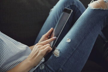 Woman working at home on her tablet