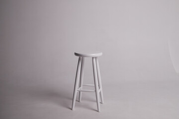 White stool with shadow on white background. Location in studio with tabouret on white background