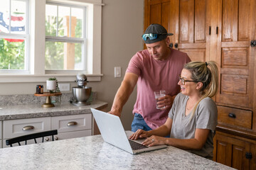 Marine veteran at home with family on a early morning in the kitchen.