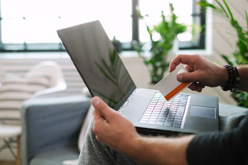 Man at home and working on laptop