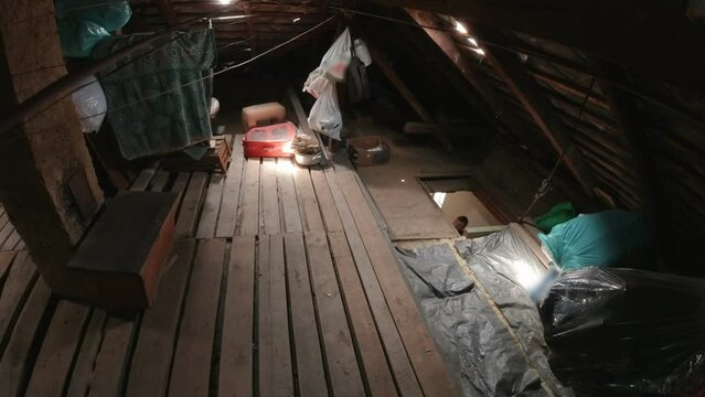 The man turns off the surveillance camera in the attic of house