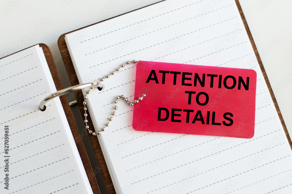 Poster attention to details text written on card with notebook