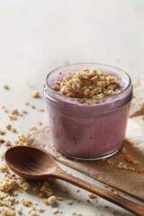 Homemade cooked healthy granola for breakfast in a wooden bowl on the table and near a bottle of milk. Place for text. Fitness food, snack