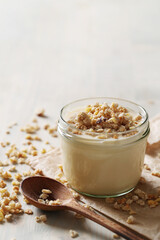 Homemade cooked healthy granola for breakfast in a wooden bowl on the table and near a bottle of milk. Place for text. Fitness food, snack