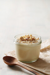 Homemade cooked healthy granola for breakfast in a wooden bowl on the table and near a bottle of milk. Place for text. Fitness food, snack