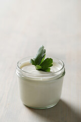 Obraz na płótnie Canvas A bowl of yogurt sitting on top of a wooden table, mayonnaise, yogurt, best mayonnaise