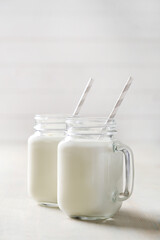 Homemade cooked healthy milk products for breakfast in a wooden bowl on the table and near a bottle of milk. Place for text. Fitness food, snack