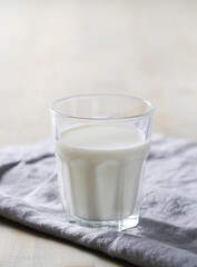 Homemade cooked healthy milk products for breakfast in a wooden bowl on the table and near a bottle of milk. Place for text. Fitness food, snack
