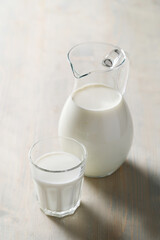 Homemade cooked healthy milk products for breakfast in a wooden bowl on the table and near a bottle of milk. Place for text. Fitness food, snack