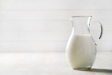 Homemade cooked healthy milk products for breakfast in a wooden bowl on the table and near a bottle of milk. Place for text. Fitness food, snack