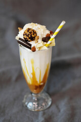 An ice cream sundae with chocolate and nuts, caramel, dessert, milkshake, gourmet