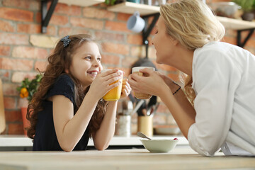 Mother and Daughter Enjoying Breakfast Together on a Sunny Morning