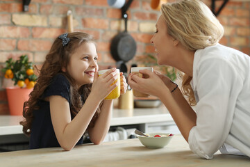 Mother and Daughter Enjoying Breakfast Together on a Sunny Morning