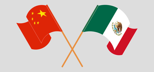 Crossed and waving flags of China and Mexico