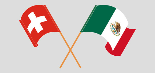 Crossed and waving flags of Switzerland and Mexico