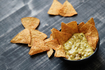 A Bowl Filled With Guacamole and Tortilla Chips
