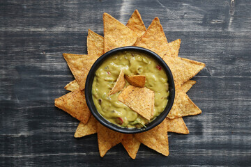 A Bowl Filled With Guacamole and Tortilla Chips
