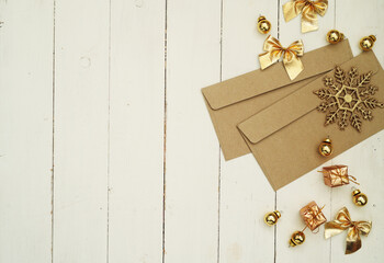 Christmas envelope with Christmas ornaments on wooden background