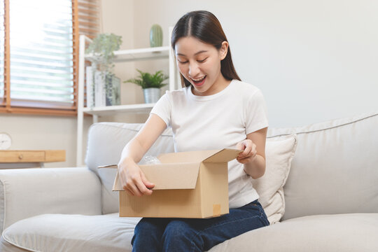 person unboxing package shopping online via internet at home