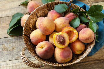 Organic fruits. Fall harvest background. Farmer's market. Basket of ripe peaches on a rustic wooden table.