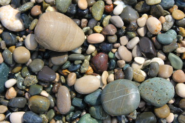 large wet multi-colored pebble stones