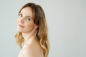 Naklejka premium Picture of of young blond woman looks at camera and pose at home