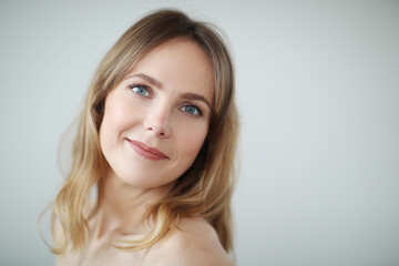 Fototapeta premium Close view of young blond woman looks at camera and pose at home