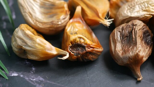 close up pf black garlic on white background table 
