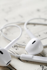 IPhone headphones on musical notes