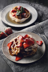Delicious sweet Belgian waffles with strawberries on the plate