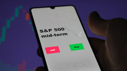 An investor's analyzing the S&P 500 mid-term etf fund on screen. A phone shows the ETF's prices sandp 500 mid term to invest