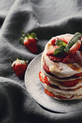 Healthy summer breakfast with classic pancakes with fresh fruits and honey in a plate