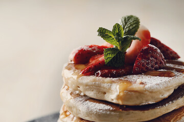 Healthy summer breakfast with classic pancakes with fresh fruits and honey in a plate