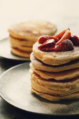 Healthy summer breakfast with classic pancakes with fresh fruits and honey in a plate