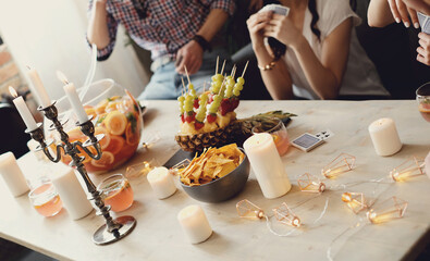 Holiday table with drinks and fruits for the company of friends