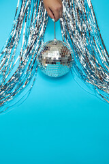 Shiny silver disco ball for parties on a blue baclground
