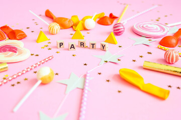 Word party of wooden letters on a pink background