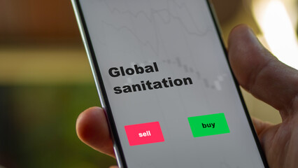 An investor's analyzing the global sanitation etf fund on screen. A phone shows the ETF's prices stocks to invest
