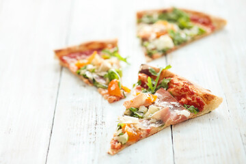 Photo of delicious hot sliced pizza with vegetables on a wooden background