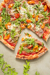 Photo of delicious hot sliced pizza with vegetables on a light background