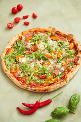 Picture of delicious hot whole pizza with vegetables on a light background