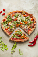 Photo of delicious hot sliced pizza with vegetables on a light background