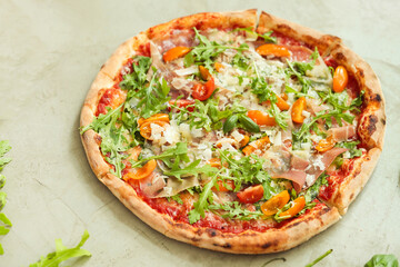 Picture of delicious hot whole pizza with vegetables on a light background
