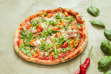 Picture of delicious hot whole pizza with vegetables on a light background